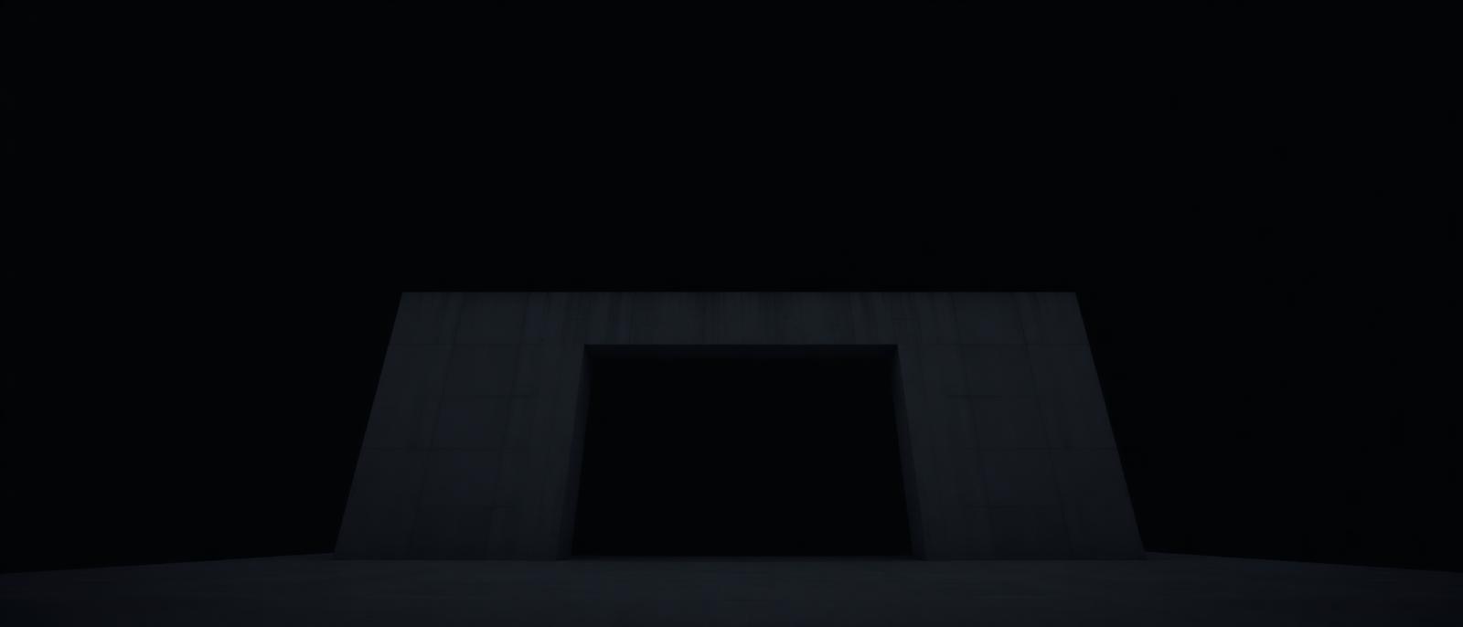 Minimalist concrete architecture against a black sky